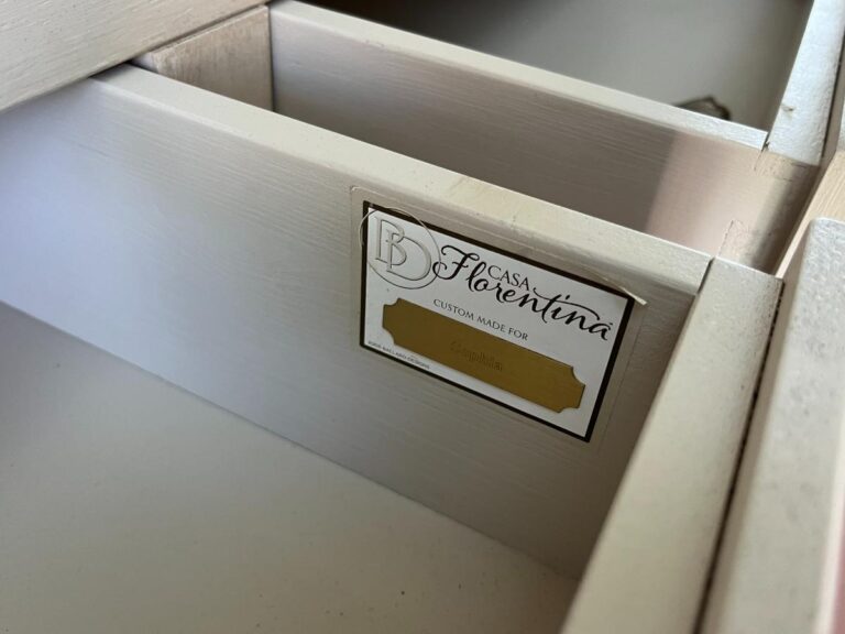 A custom-made drawer with a label displaying "Casa Florentina" and "Custom Made For." The drawer appears to be open, showing its internal structure.