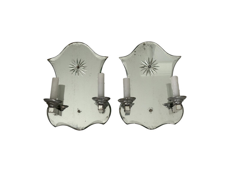 A pair of Vintage Mirrored Double Arm Sconces with candle holders, featuring a starburst design and a distressed silver finish.