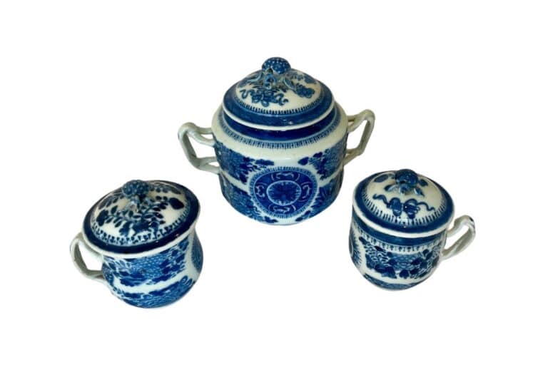 Three blue and white ceramic jars with lids and handles, featuring intricate floral and geometric patterns.