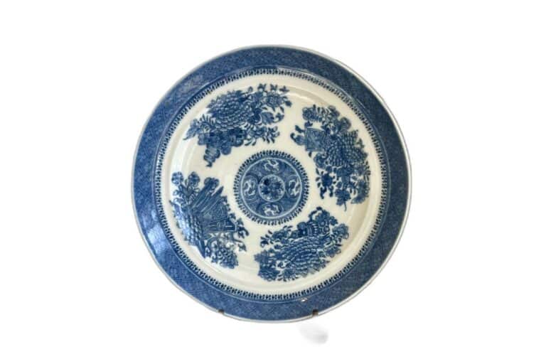 A blue and white porcelain plate with intricate floral patterns and a central medallion design.