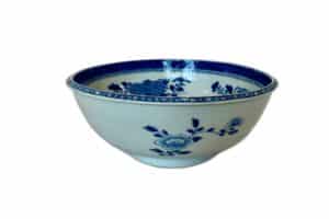 A white ceramic bowl with blue floral patterns and decorative designs around the rim.