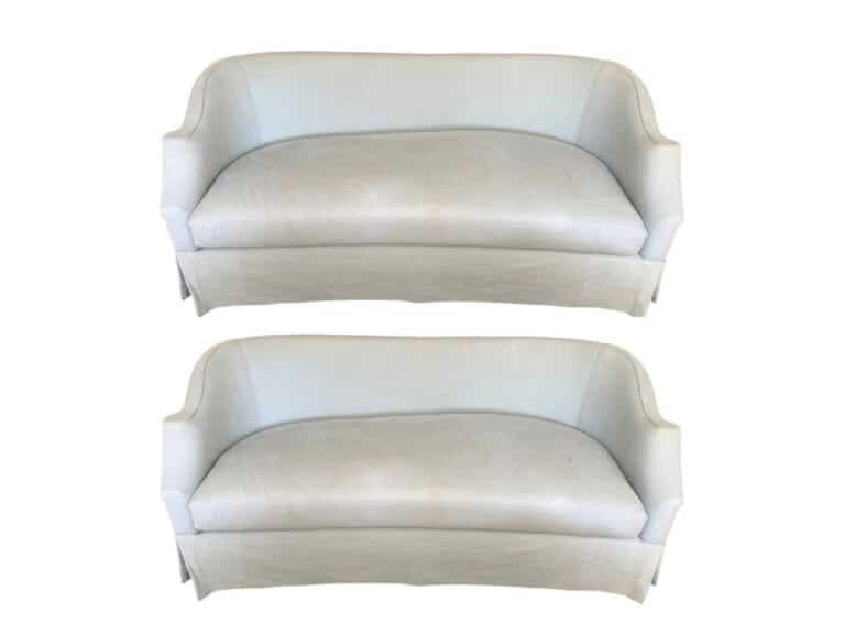 Pair of Niermann Weeks Tight Back Blue Sofas featuring curved backs and skirts.