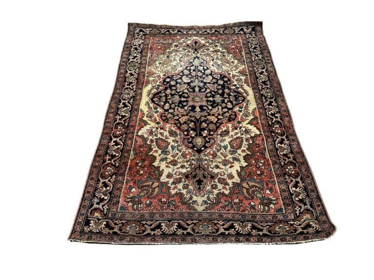 A detailed Persian rug with intricate floral and geometric patterns in red, black, and cream colors.