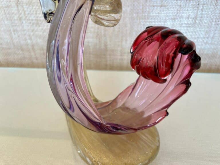 Barbini Murano Bird of Paradise Italian Art Glass Sculpture featuring a swirled purple and red design on a beige base, set against a textured background.