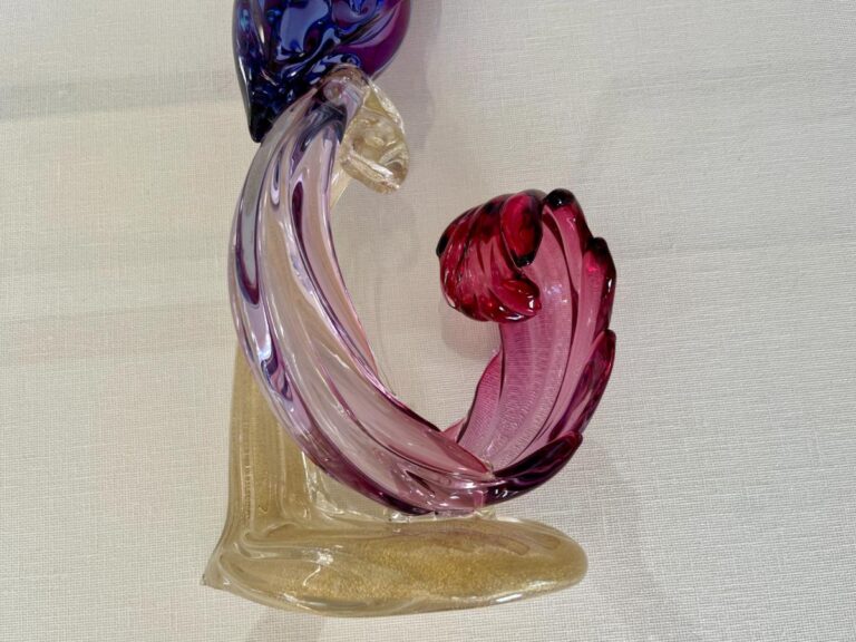 Close-up of the Barbini Murano Bird of Paradise Italian Art Glass Sculpture featuring colorful, abstract twists in shades of pink, purple, and amber against a plain white background.