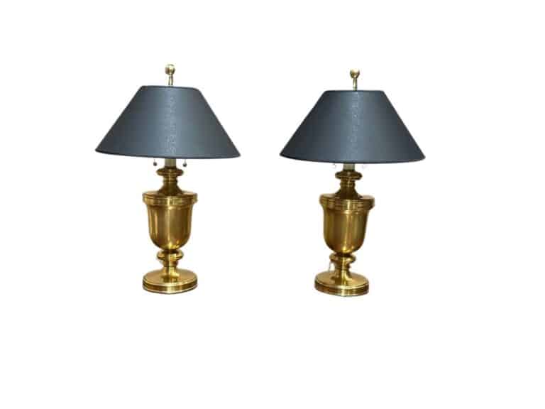 Two gold table lamps with dark gray shades on a white background.