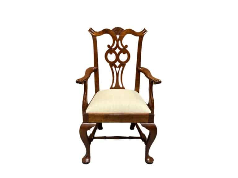 A wooden armchair with an intricate backrest design and a white cushioned seat, shown against a plain white background.