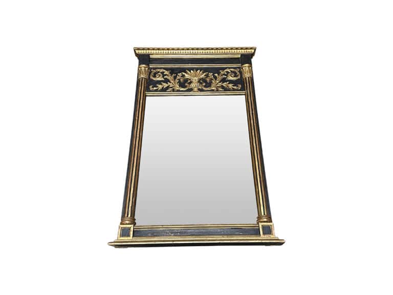 Ornate rectangular mirror with a gold and black frame, featuring decorative floral carvings at the top.