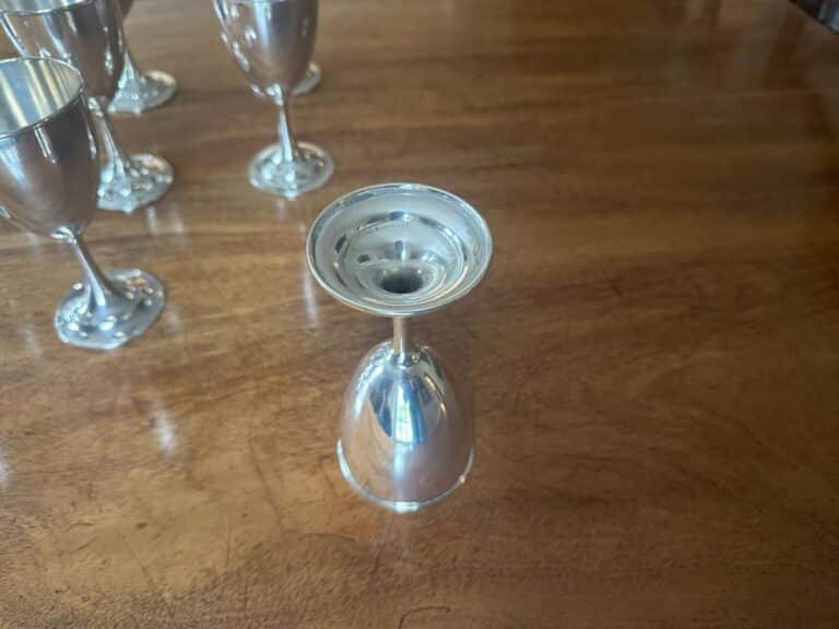 An International Silver Co Sterling Silver Goblet 'P58' is placed upside down on a wooden table, with several similar goblets in the background.