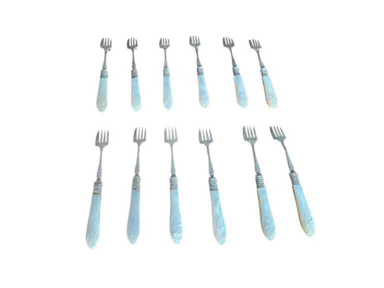 Twelve matching silver and pearl-handled dessert forks arranged in three rows on a white background.