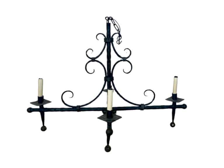 The Antique Iron Forged Four Light Chandelier features ornate scrollwork, a central hanging chain, and holds four candles.