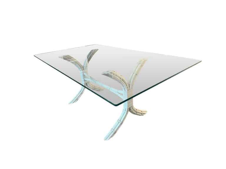 David Francis dining table featuring a rectangular glass top and a painted rattan base with artistic, curved legs.