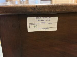 Label on wooden furniture showing "English Traditions, Cincinnati - Ohio," with shipping number 8010, Pieces in Lot, Order No., and "Made in England.