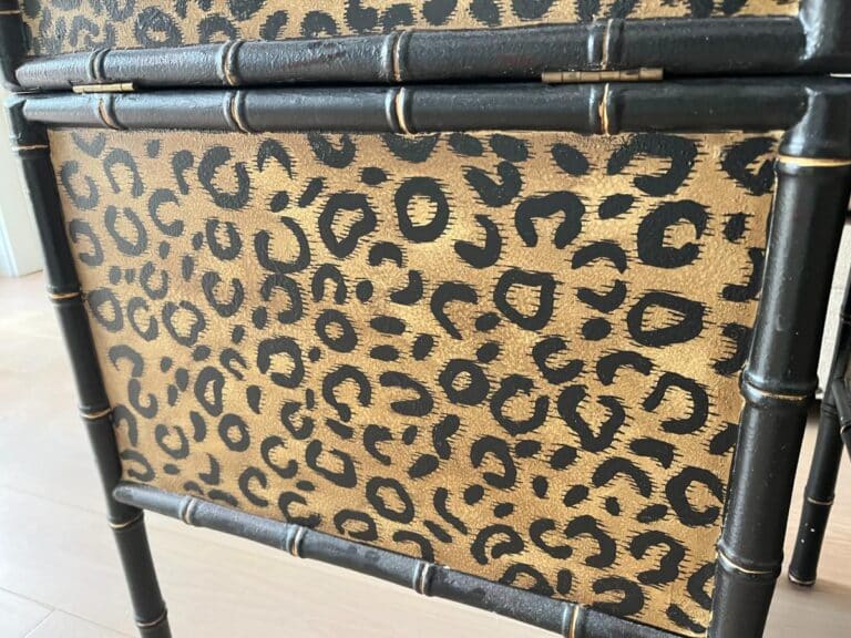 Close-up of a piece of furniture with a leopard print design and bamboo-style frame.