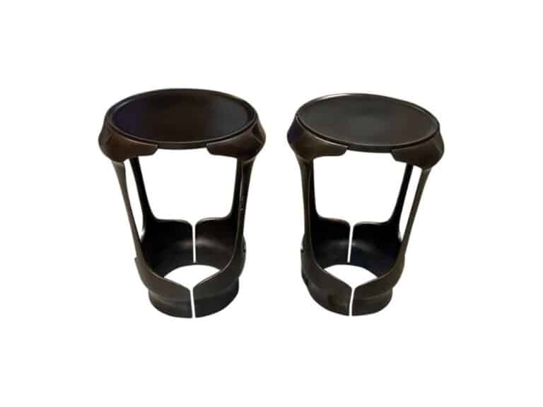 Two Holly Hunt Forsythe side tables in black plastic, each with three vertical supports and an open bottom space designed for holding soda cans.