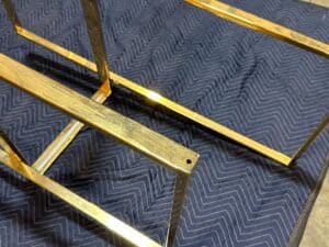 Gold-colored metal frame on a dark blue chevron-patterned fabric.