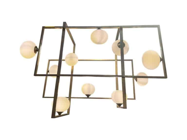 The Vintage Brass Rectangular Ten Light Chandelier features a modern design with multiple spherical bulbs set within a geometric metal frame.