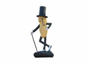 A "Life Size" Mr. Peanut statue made of cast iron, depicting the smiling peanut character in a top hat and monocle, holding a cane and stepping forward with one leg.