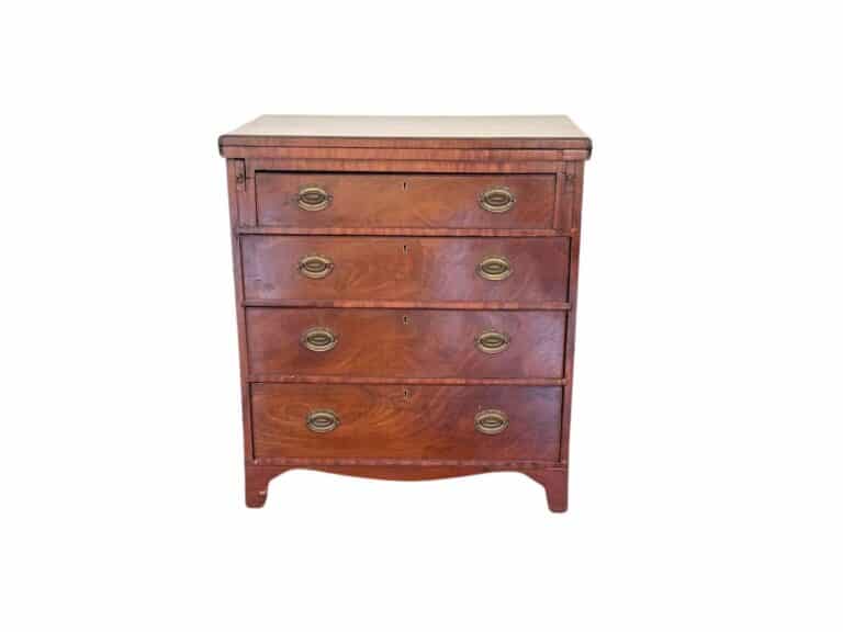 A Bachelor's Chest of Drawers featuring a vintage design, four wooden drawers, and brass oval handles set against a white background.