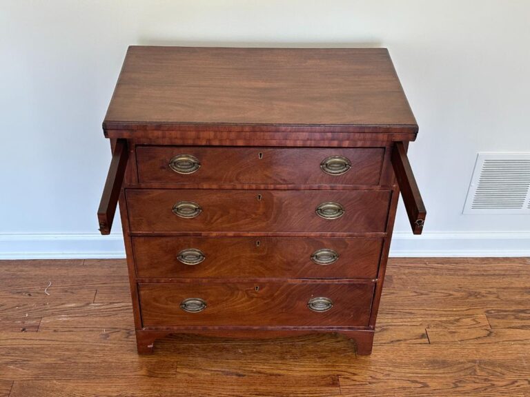 The Bachelor's Chest of Drawers is a wooden chest featuring brass handles and slide-out extensions on each side.