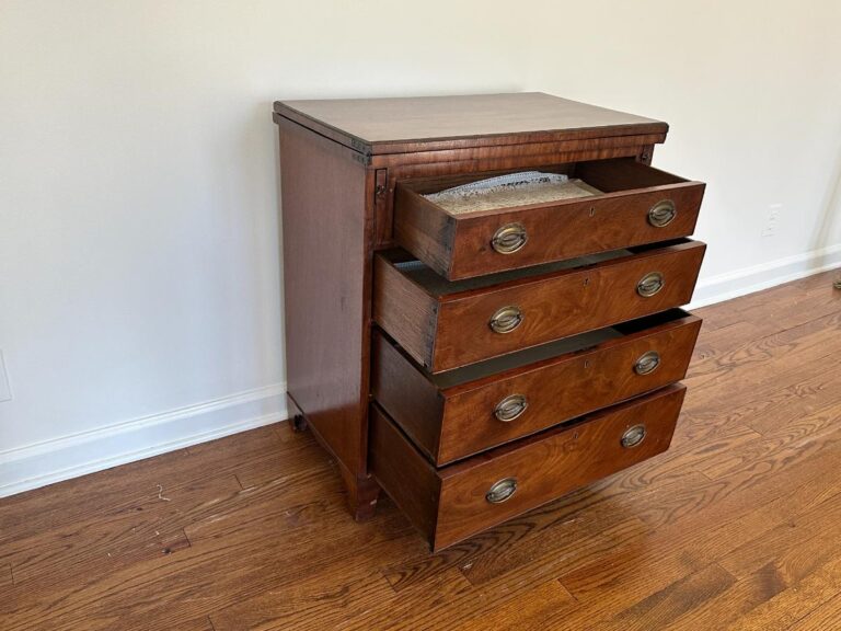 Bachelor's Chest of Drawers showcasing five drawers, with two partially open, sits in a room with a hardwood floor.