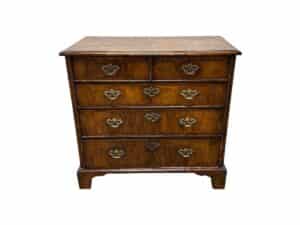 Antique Burl Chest of Drawers featuring five wooden drawers and ornate metal handles on a white background.
