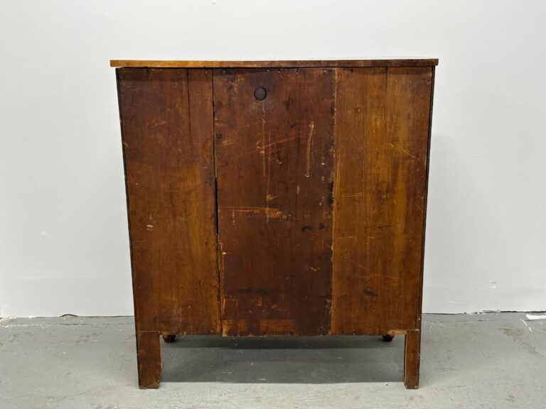 A vintage wooden cabinet with a worn finish against a plain background.