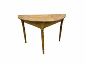 A wooden half-moon table with three turned legs on a white background.