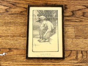Antique framed print of a sad child entitled "Nobody Loves Me" by VC Andrews, featuring a child wearing a hat and boots on steps, copyright 1906 by Charles Scribner & Sons.
