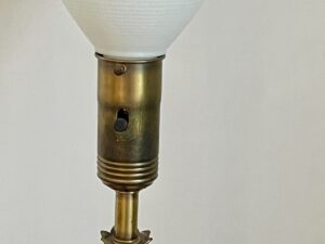 A close-up of the Vintage Pineapple Crystal & Brass Lamp features a brass socket and white lampshade against a plain background.