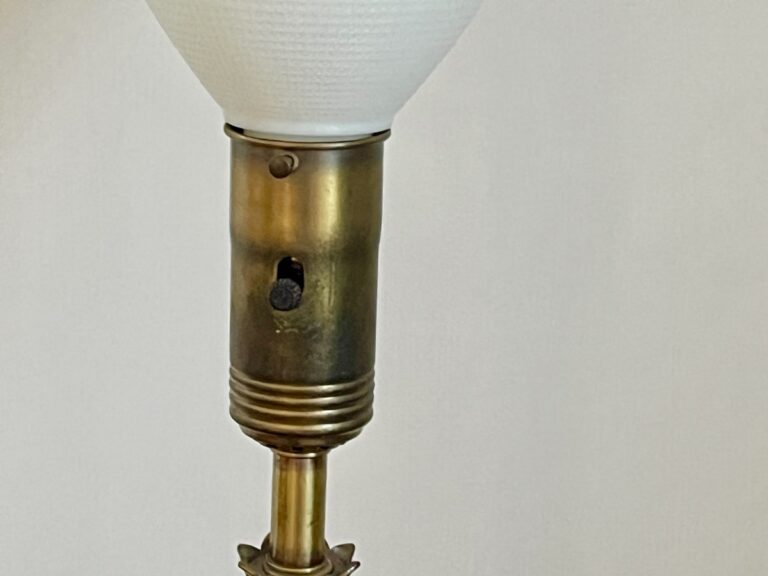 A close-up of the Vintage Pineapple Crystal & Brass Lamp features a brass socket and white lampshade against a plain background.