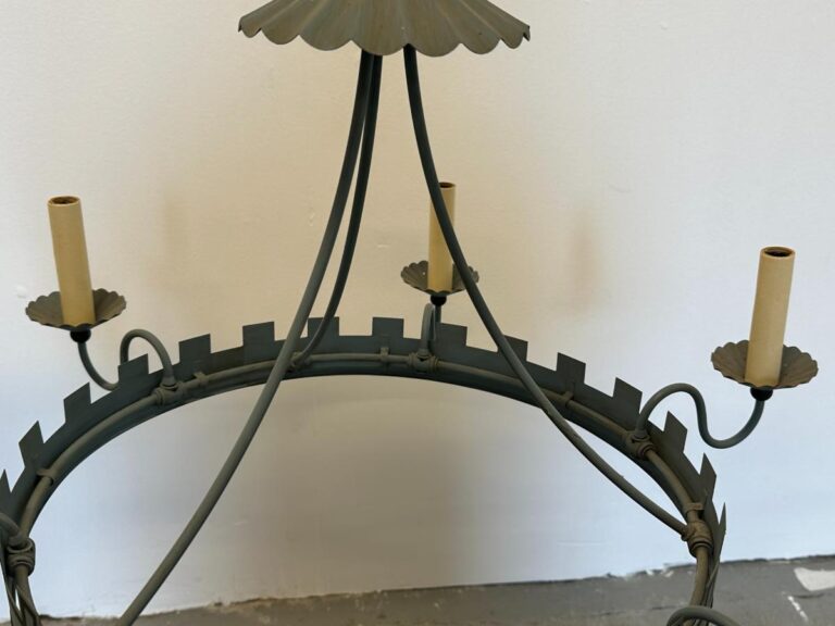 Vintage metal chandelier with candle holders, featuring a circular design and scalloped edges.