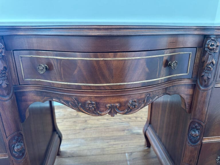 French Carved Mahogany Vanity Ladies Desk with ornate carvings, two floral knobs, and a polished brown finish.