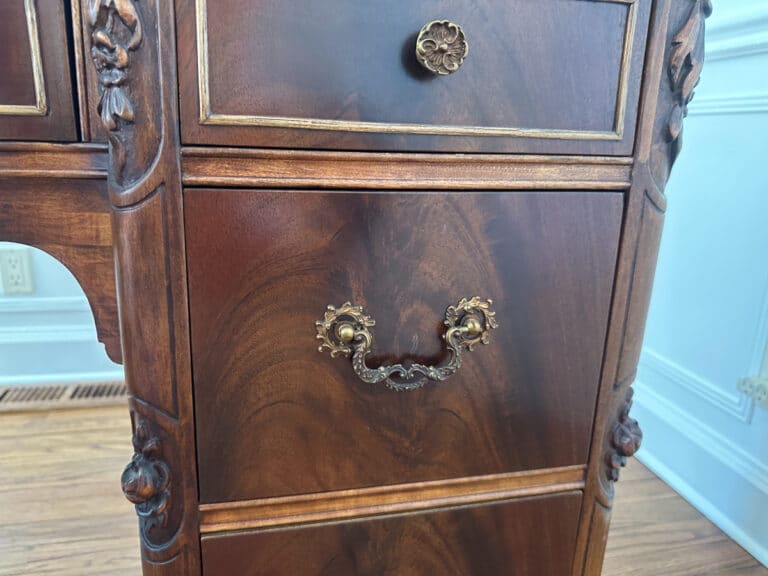Close-up of an ornate drawer from the French Carved Mahogany Vanity Ladies Desk, featuring intricate carved details and a brass handle in an elegant design.