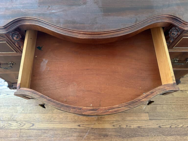 Open a drawer with ornate handles on the French Carved Mahogany Vanity Ladies Desk, showing an empty interior and wood grain texture.