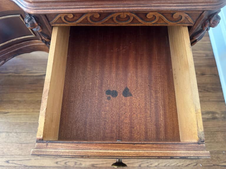 Open the French Carved Mahogany Vanity Ladies Desk's antique wooden drawer, revealing its ornate carvings and dark stains inside.