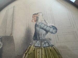 A vintage illustration from the "Passé Temps Des Dames Framed Prints, Set of 2" features a woman in a 19th-century dress, hand on chin, posing in a paneled room.