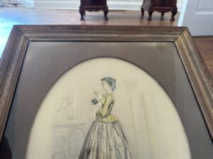 Set of 2 framed prints titled "Passé Temps Des Dames," featuring a woman in historical attire holding an object, with furniture visible in the background.