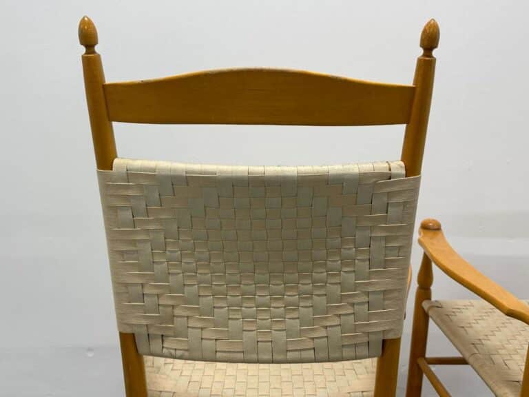 Wooden chair with a woven backrest, featuring a natural finish and simple design.