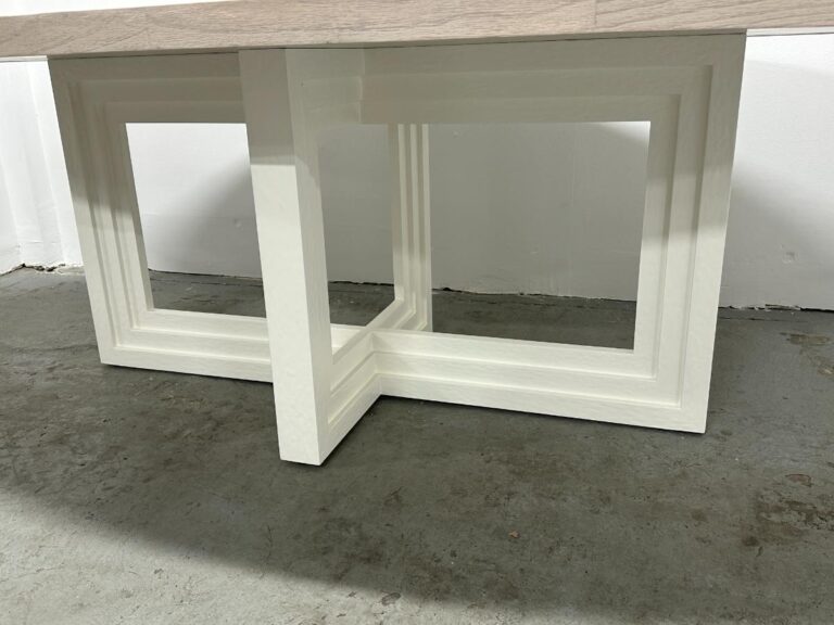 Mr. Brown London Florence Dining Table featuring a geometric, white base design on a concrete floor.