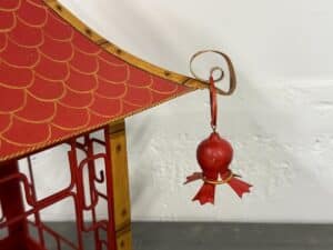 Red and gold decorative pagoda detail with a small hanging ornament on the corner.