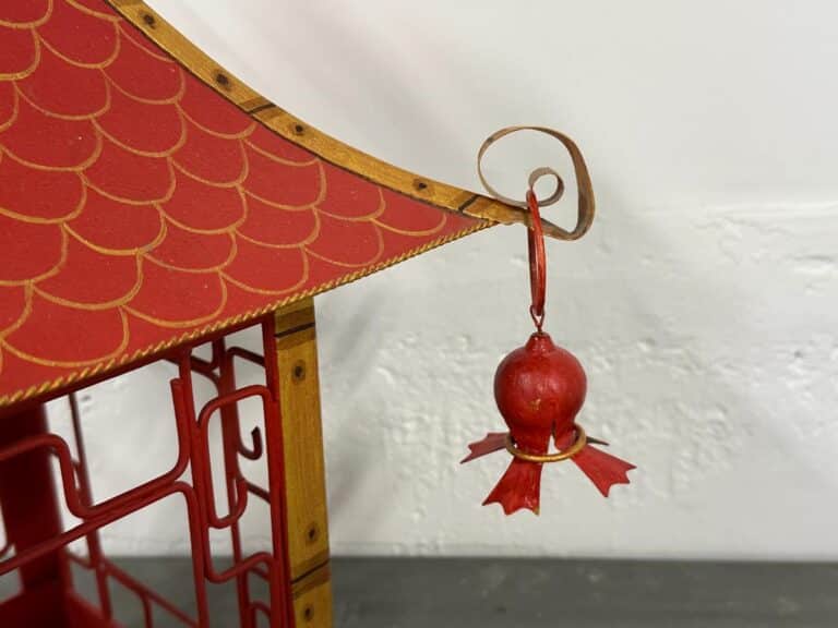 Red and gold decorative pagoda detail with a small hanging ornament on the corner.