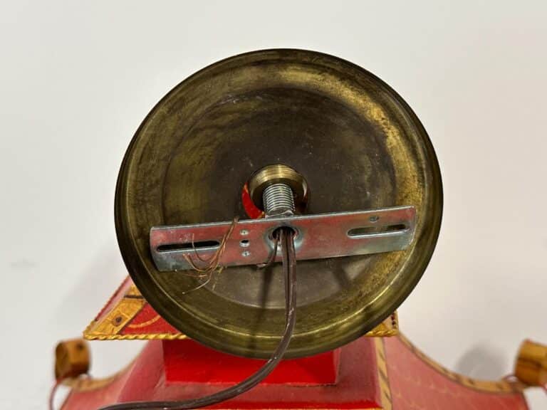 Close-up of the underside of a light fixture showing wiring and a metal bracket attachment.