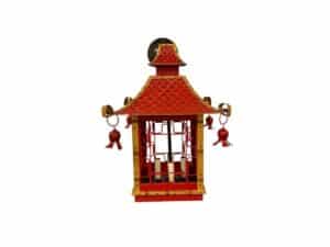 Red and gold decorative lantern with a roof-like top and ornamental details.