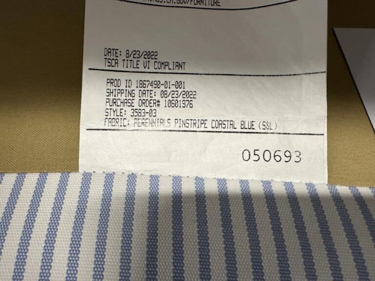 Close-up of a fabric label and blue striped fabric, featuring Serena & Lily Barton Sofa details printed above.