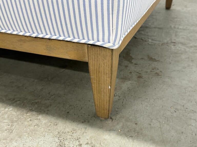 Serena & Lily Barton Sofa featuring a wooden leg with a blue and white striped fabric frame, displayed on a concrete floor.
