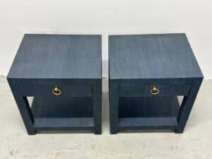 A pair of Serena & Lily Driftway one-drawer nightstands, featuring a square shape, black finish, and gold ring pulls, placed on a light concrete floor.