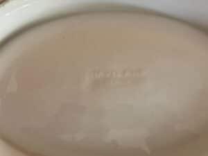 Underside of a dish with the faint word "Haviland" embossed on its surface.