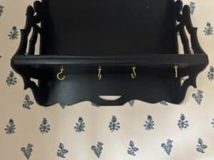 Blue Wall Shelf / Bracket featuring four gold hooks set against a floral-patterned wallpaper.