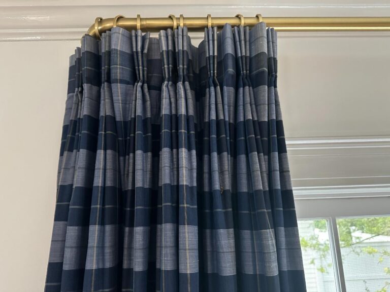 Blue Stripe Panels, Set of 6, hang on a brass rod by the window.